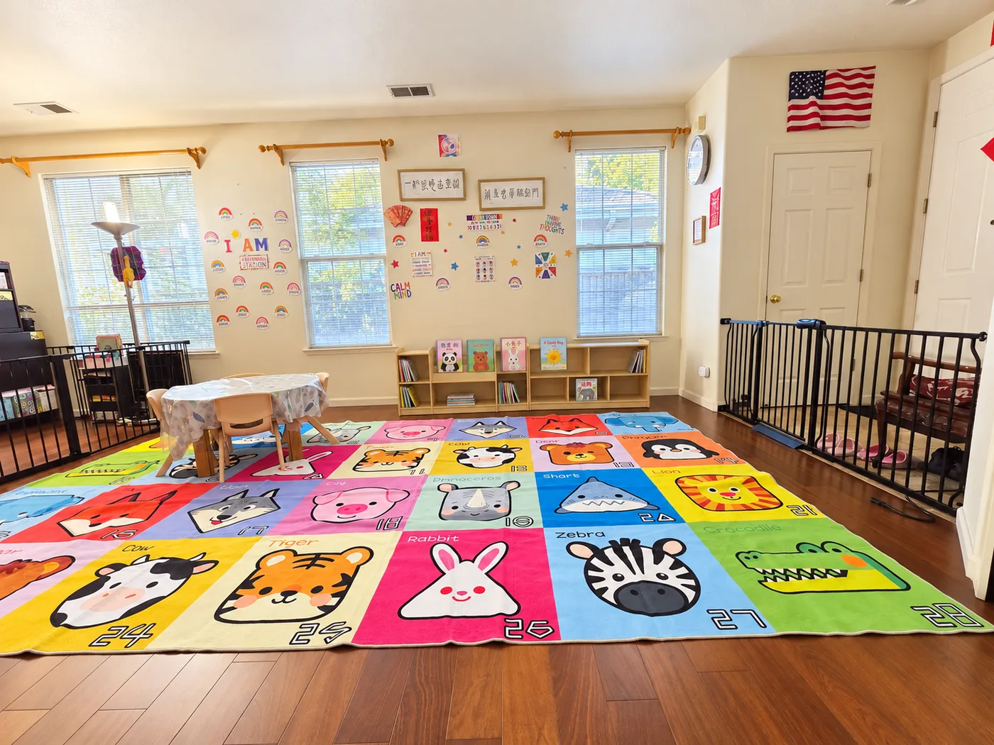 Lia's Preschool playroom in Danville, CA with a low book shelf, child-sized table and chairs, and a large alphabet play mat