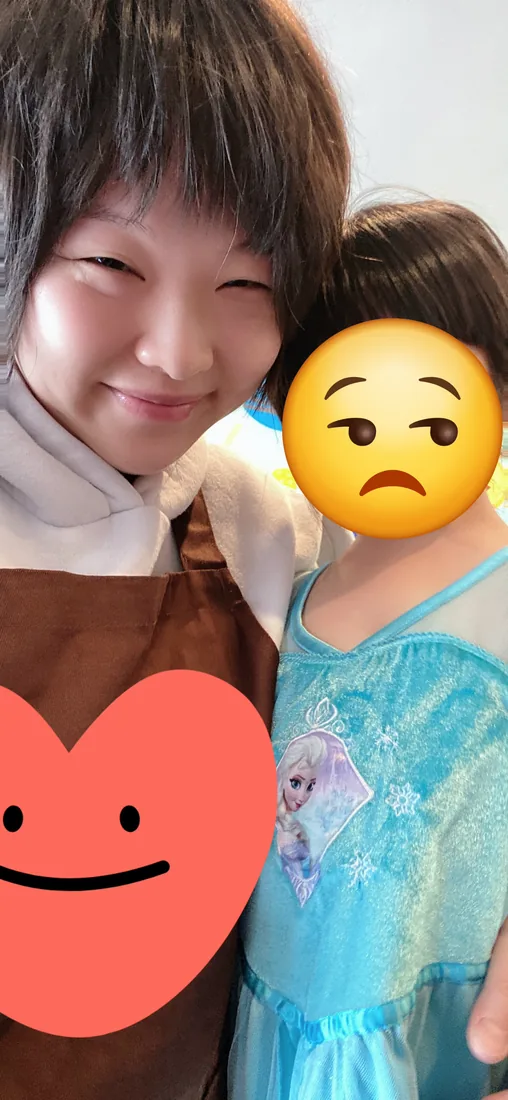 Lia with a preschooler in a dress-up costume during indoor play